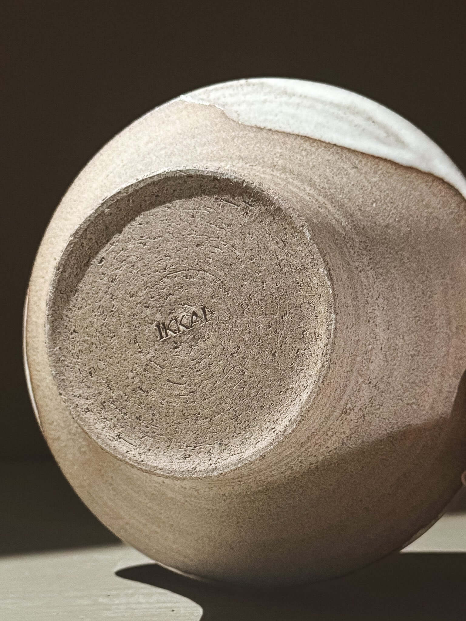 Bowl - Yuki Ash showcasing the underside with a smooth ash-grey clay and glossy white glaze finish.