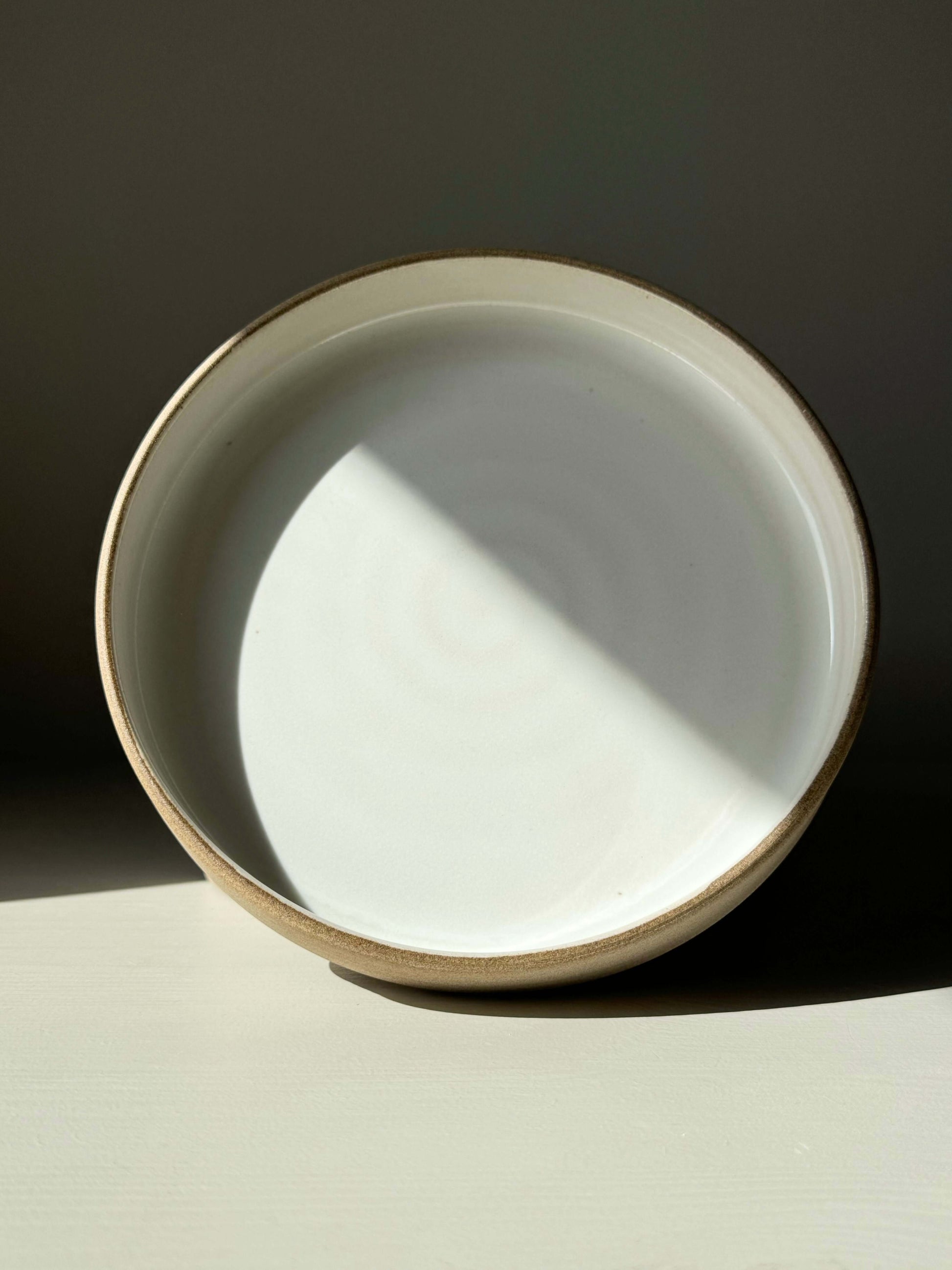 Yuki Series ceramic plate with glossy white glaze and toffee-colored clay, designed for calm moments and soft light, perfect for cozy dining.
