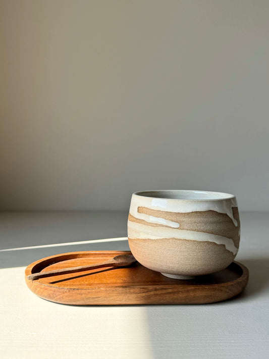 Yuki Series coffee cup with unique white glaze on toffee clay, resting on a wooden tray. Elegant and handcrafted ceramic design.