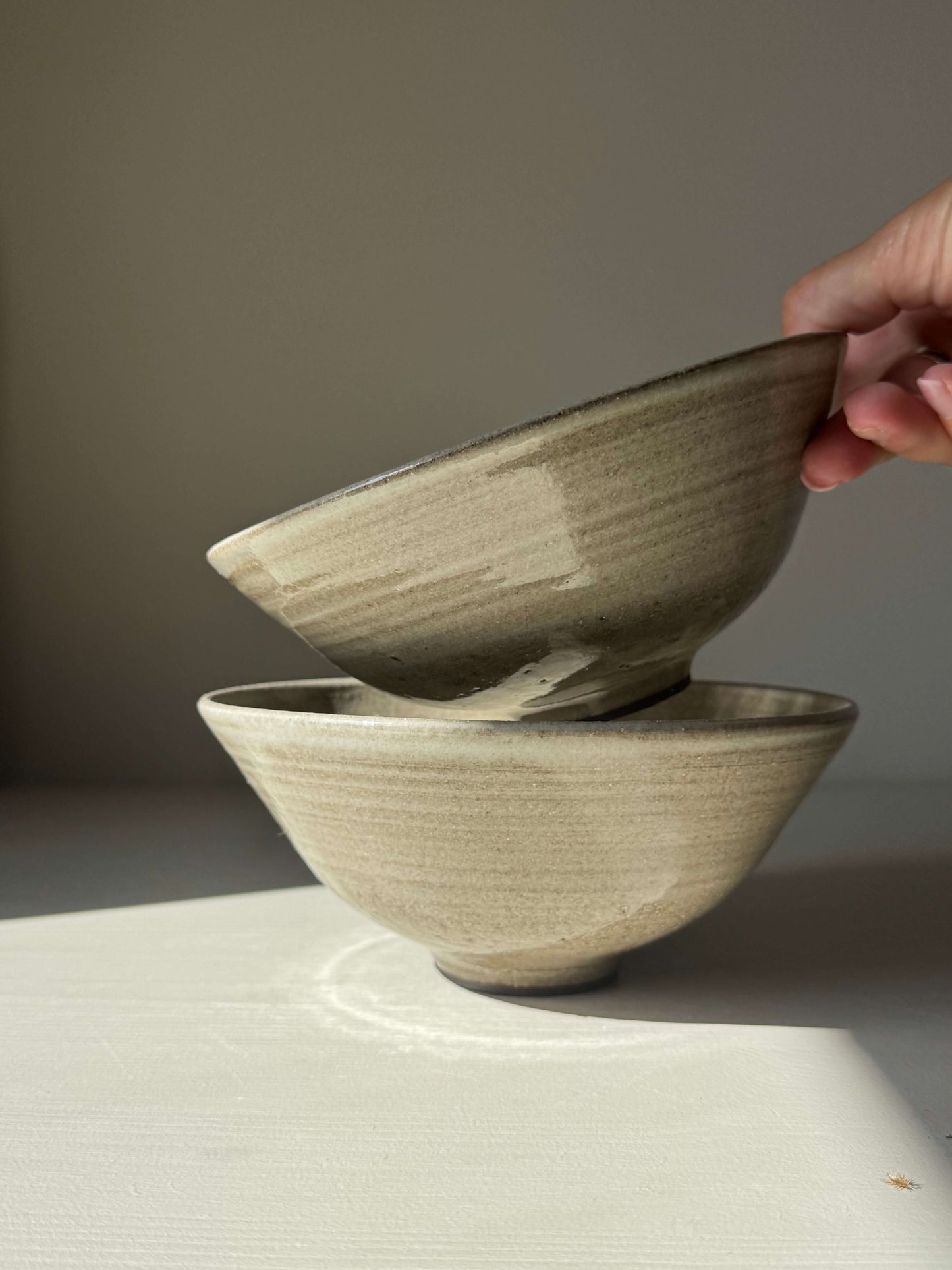Handmade ceramic Bowl – Yuki Series Dark Clay with soft white glaze, showcasing the wide, open shape and unique glaze pattern.