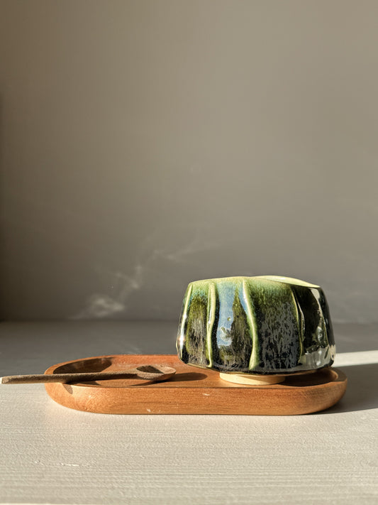 Yunomi Cup - Hinoki #04 with deep green glaze and flowing slip lines, resting on a wooden tray in natural light.