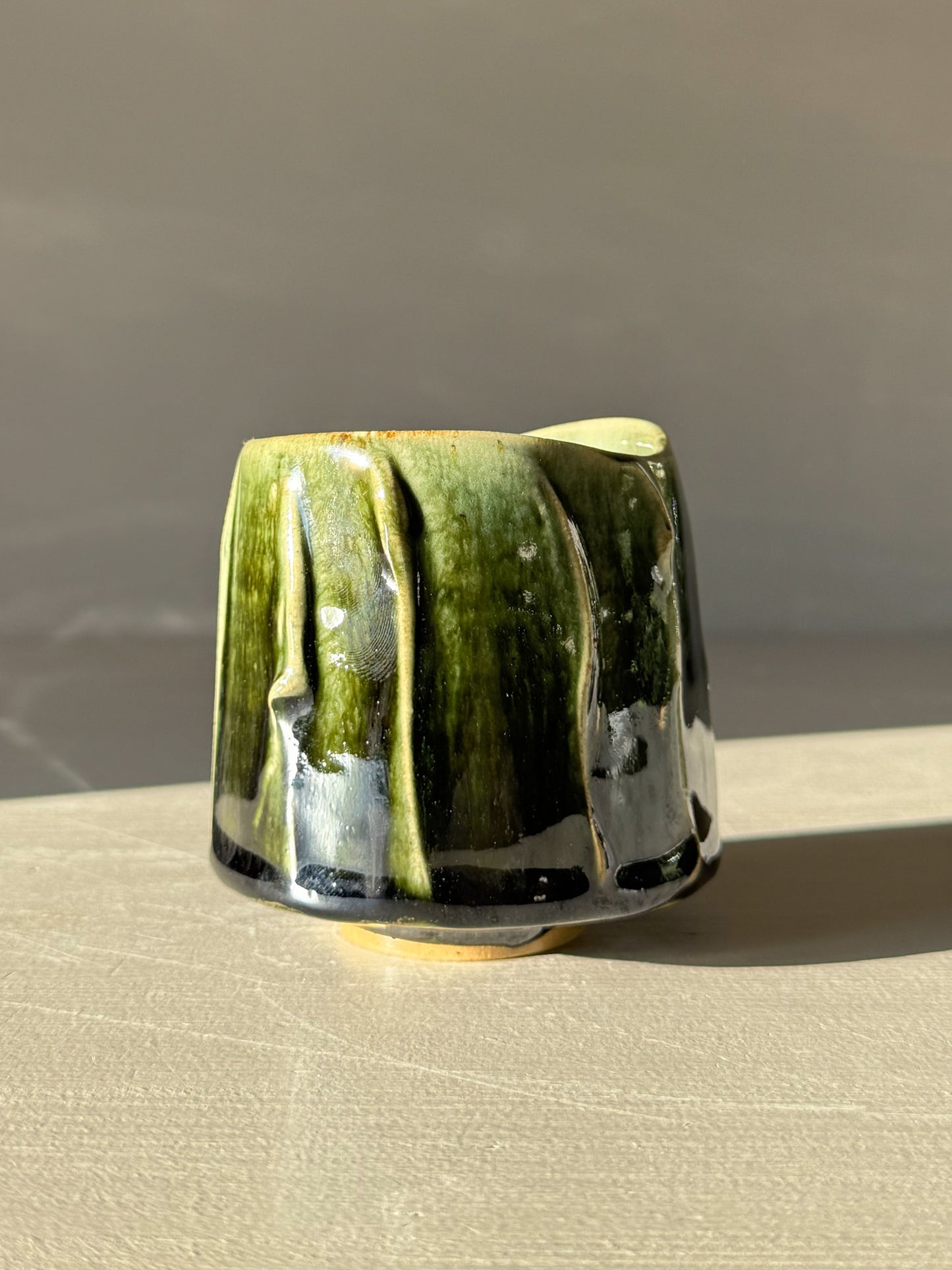 Yunomi Cup - Hinoki #13 with hand-decorated slip and deep green glaze, emphasizing unique texture and variation.