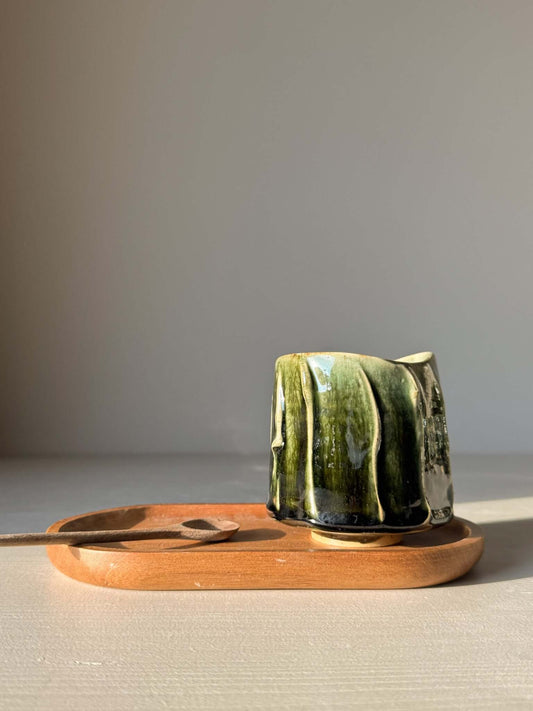 Yunomi Cup - Hinoki #13 with deep green glaze and handmade texture on a wooden tray