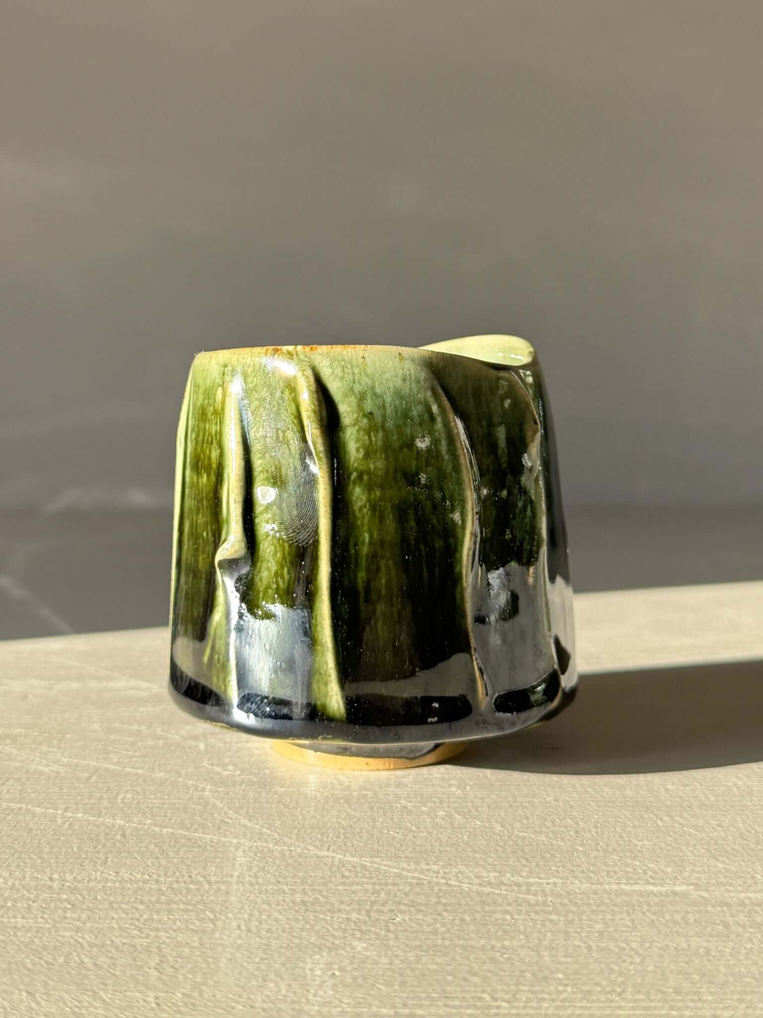 Yunomi Cup - Hinoki #13 with hand-decorated slip and deep green glaze, emphasizing unique texture and variation.