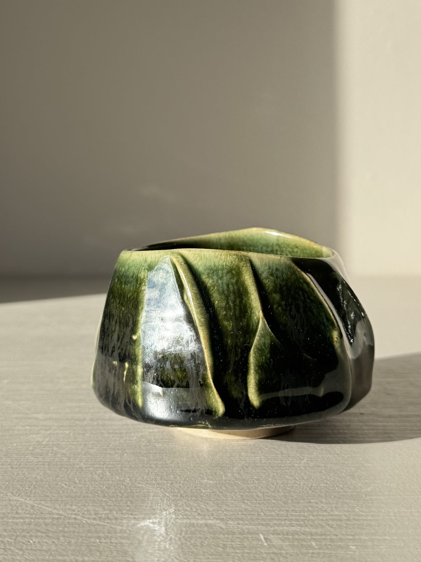 Yunomi Cup - Hinoki #30 with deep green glaze and flowing slip decoration, showcasing unique texture and craftsmanship.