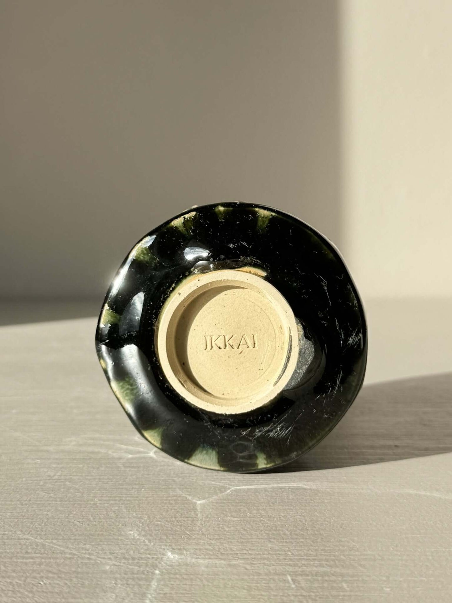 Yunomi Cup - Hinoki Series #20 with deep green glaze and handcrafted slip texture, showcasing uniqueness of each cup. Base marked "IKKAI."