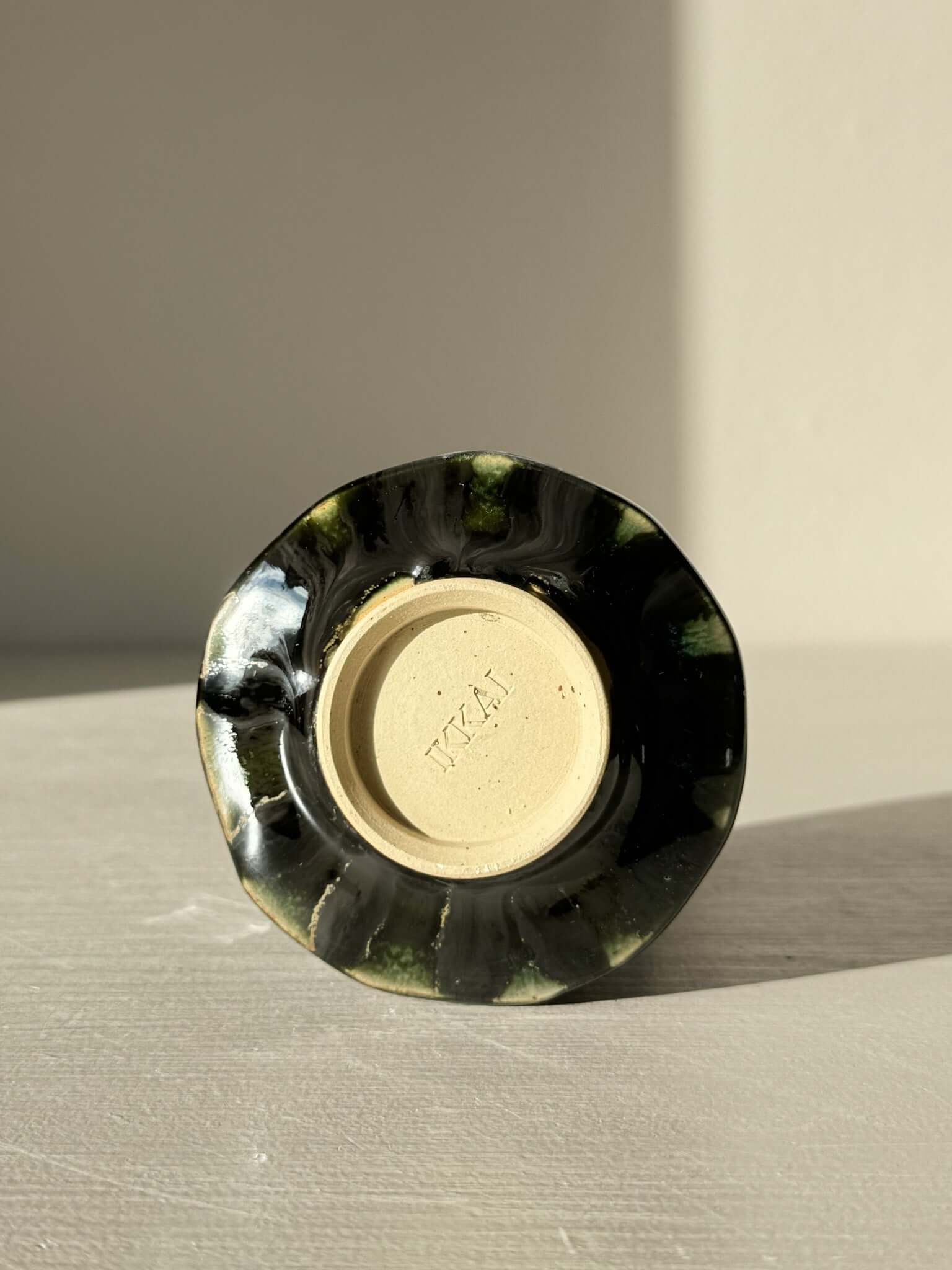 Base view of Yunomi Cup - Hinoki Series #21 showing unique slip decoration and deep green glaze variation.