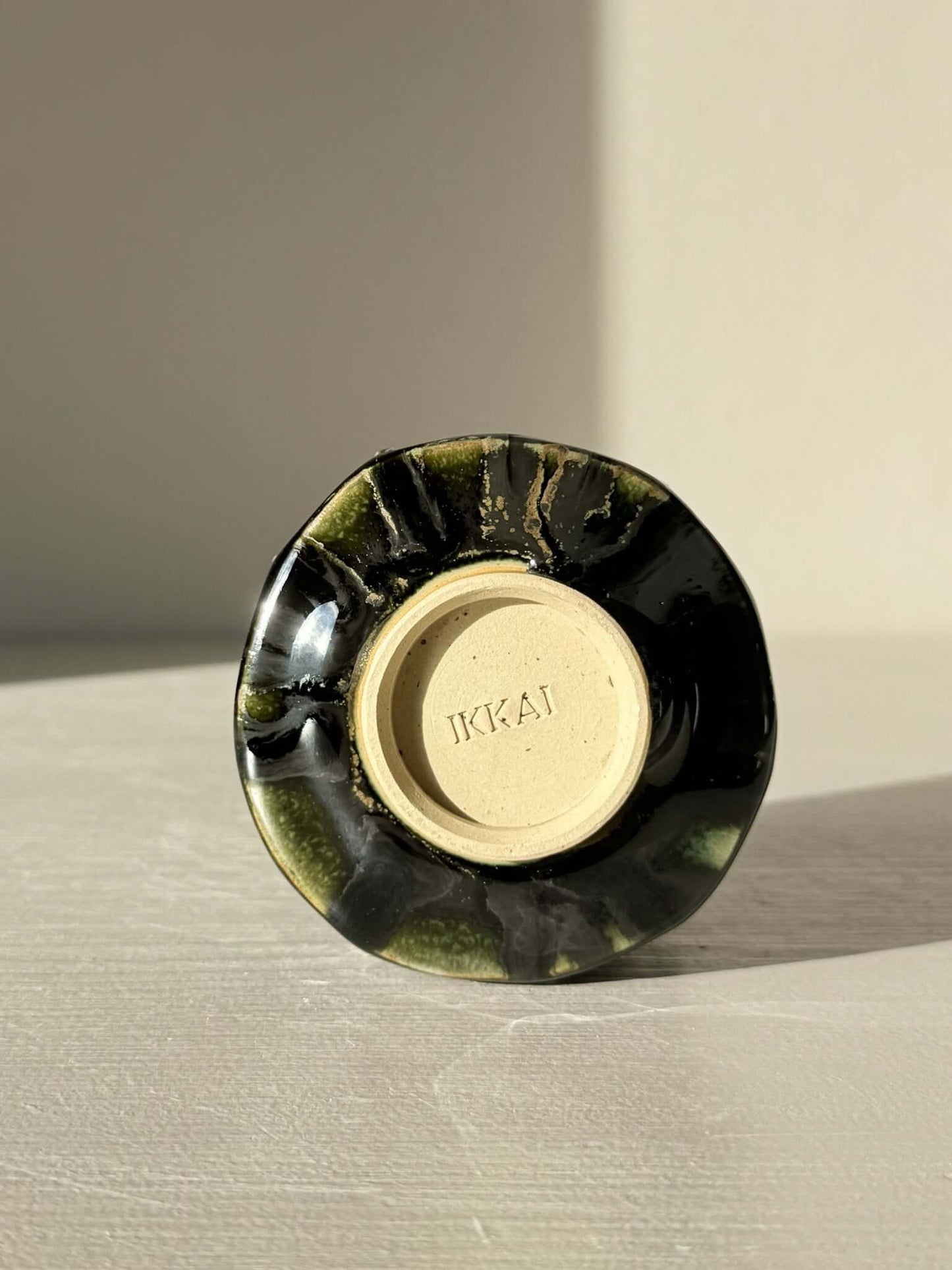 Base view of Yunomi Cup - Hinoki Series #22 with deep green glaze and unique texture.