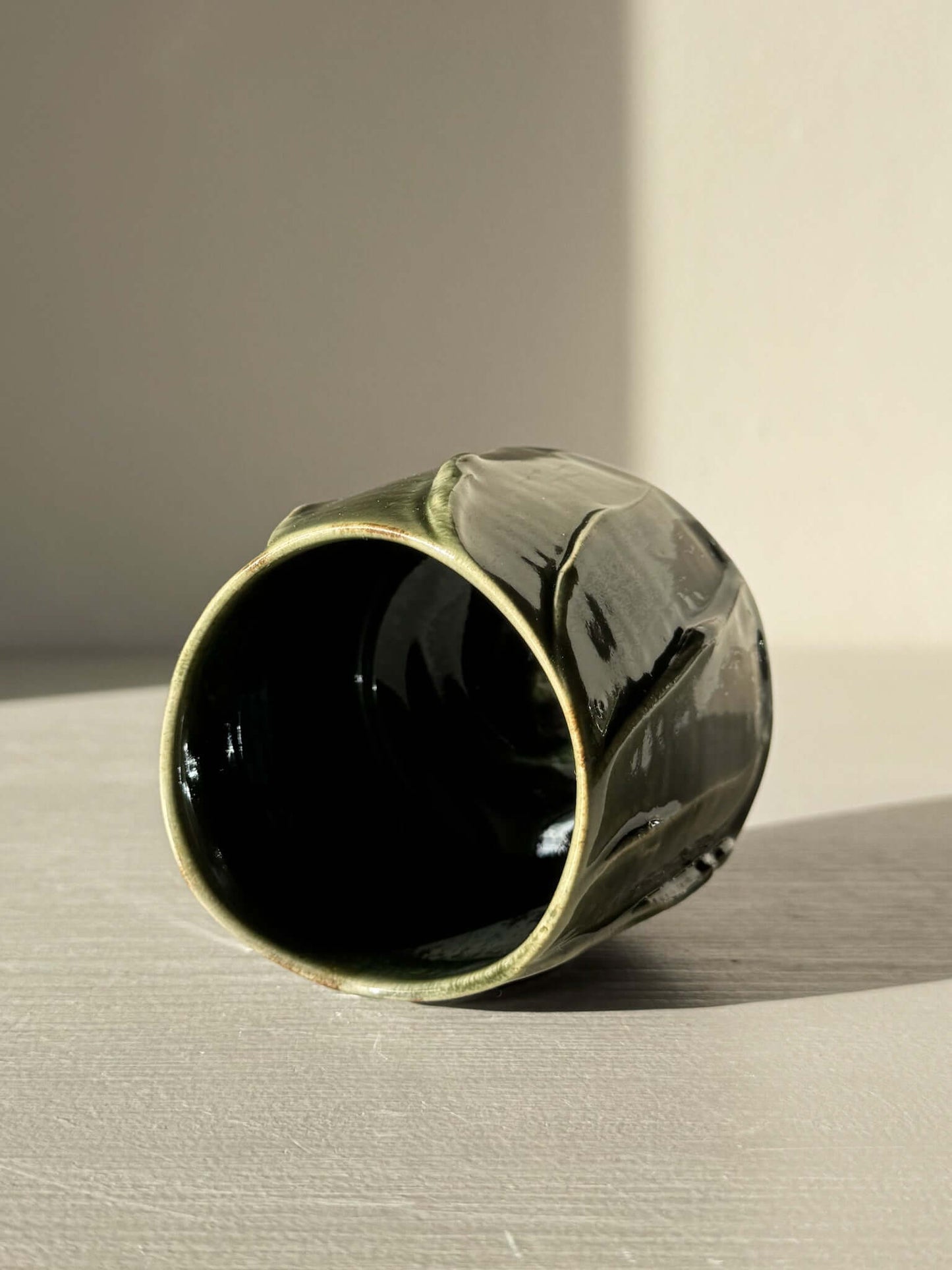 Deep green glazed Yunomi Cup - Hinoki Series #22 with flowing texture lines on a light surface