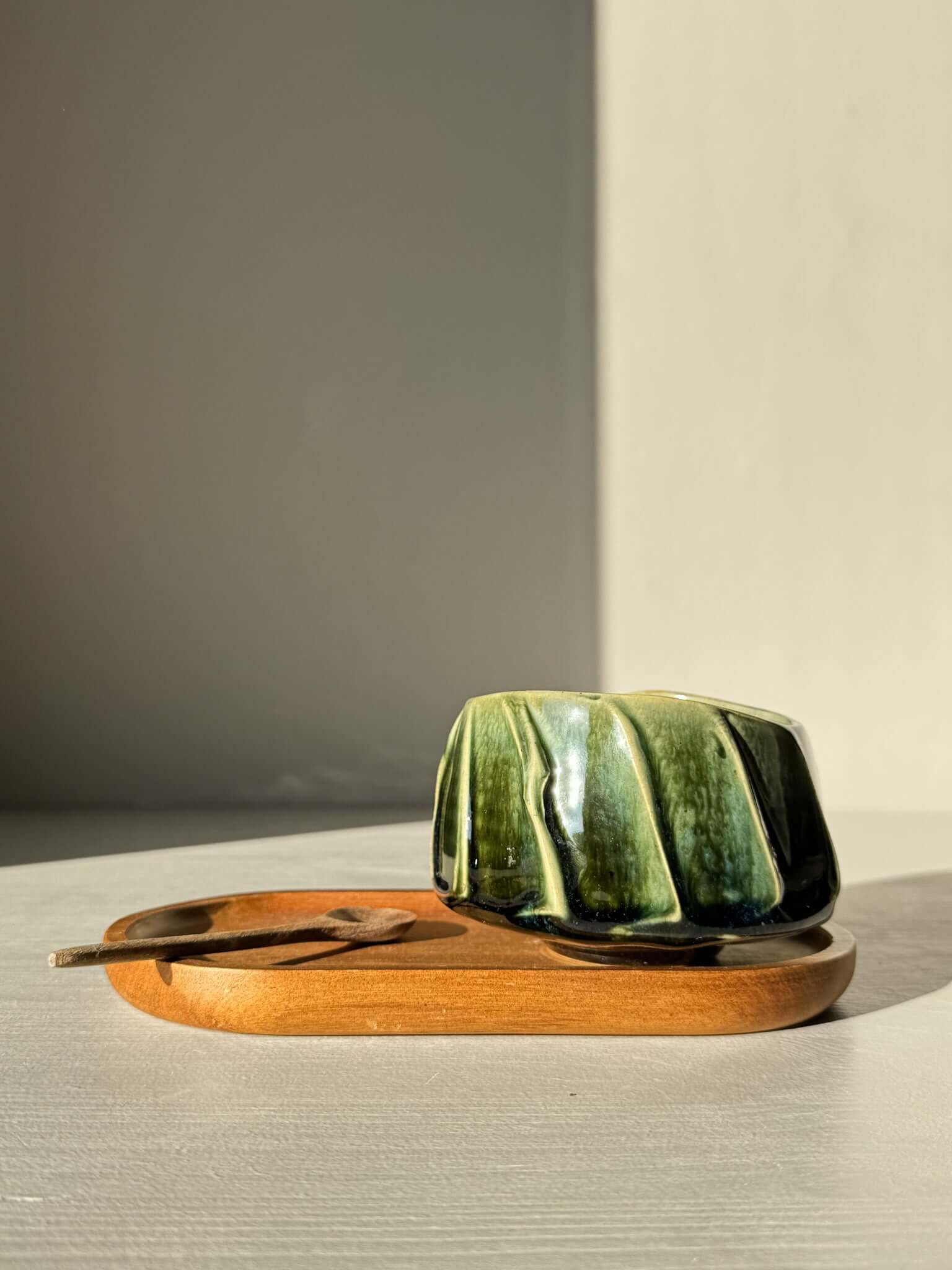 Yunomi Cup - Hinoki #28: Handcrafted green glazed cup with textured slip design, displayed on a wooden tray.