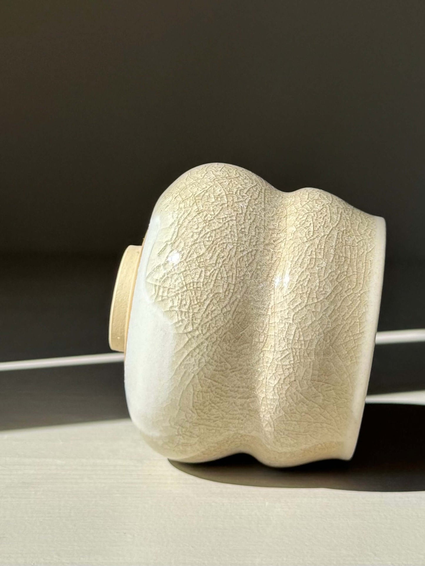 Handmade ceramic Yunomi Cup - Kannyū Series #03 with crackle glaze design, highlighting the cup's elegant texture and fine lines.
