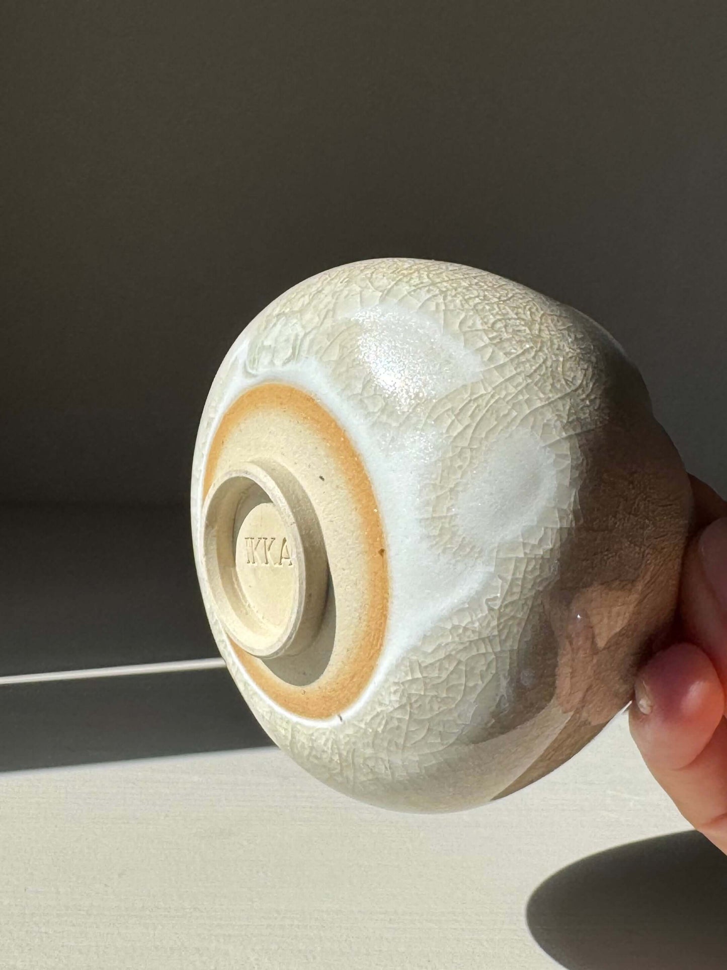 Bottom view of Yunomi Cup - Kannyū Series #06, handmade ceramic with transparent crackle glaze.