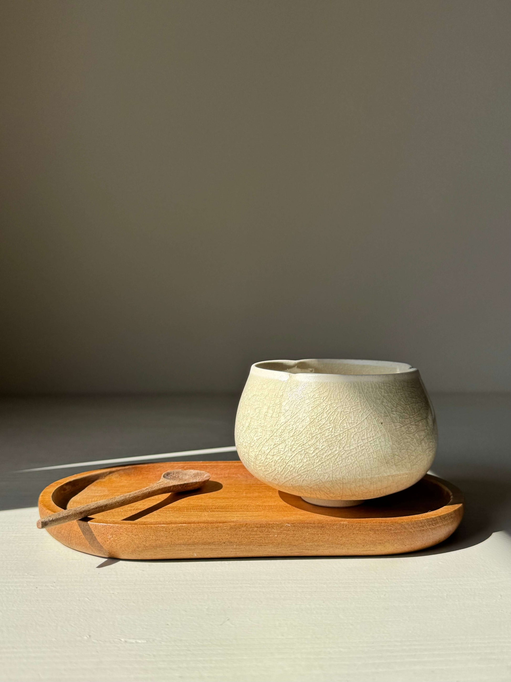 Handmade ceramic Yunomi Cup - Kannyū Series #06 with crackle glaze on a wooden tray.