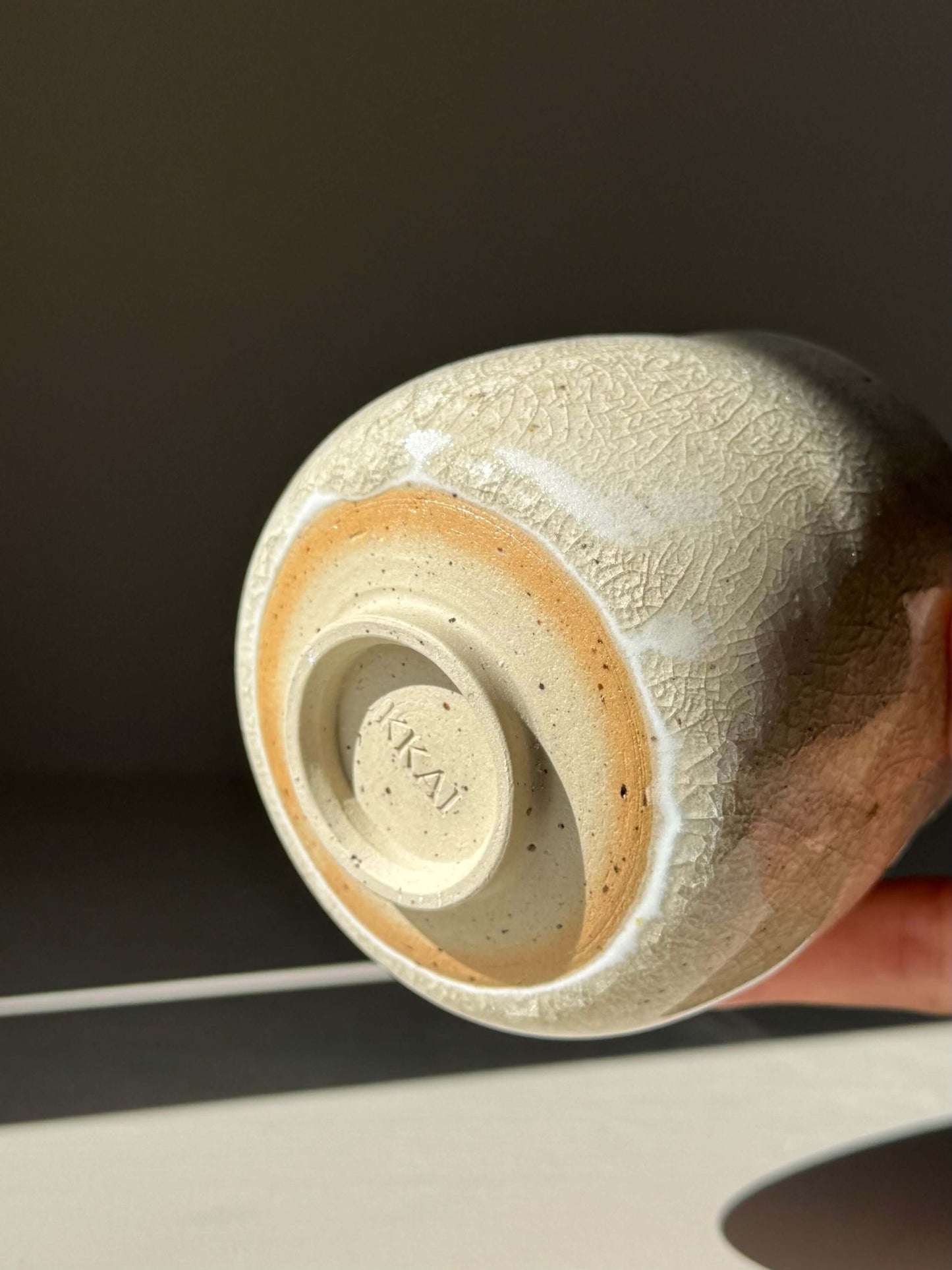 Handmade ceramic Yunomi Cup - Kannyū Series #09 with crackle glaze highlighting delicate patterns of fine lines in sunlight.