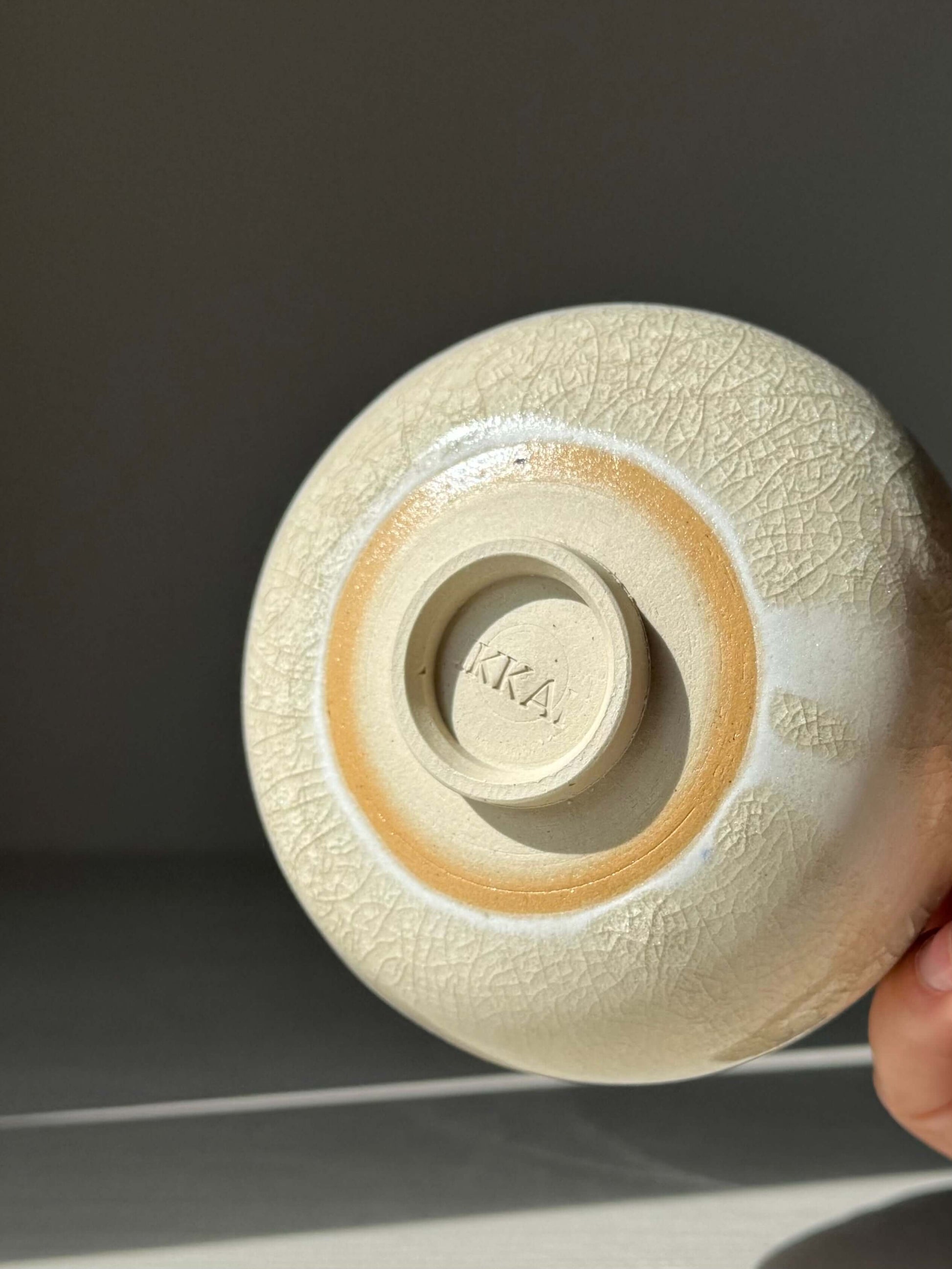 Bottom view of handmade ceramic Yunomi Cup - Kannyū Series #12 with crackle glaze details.