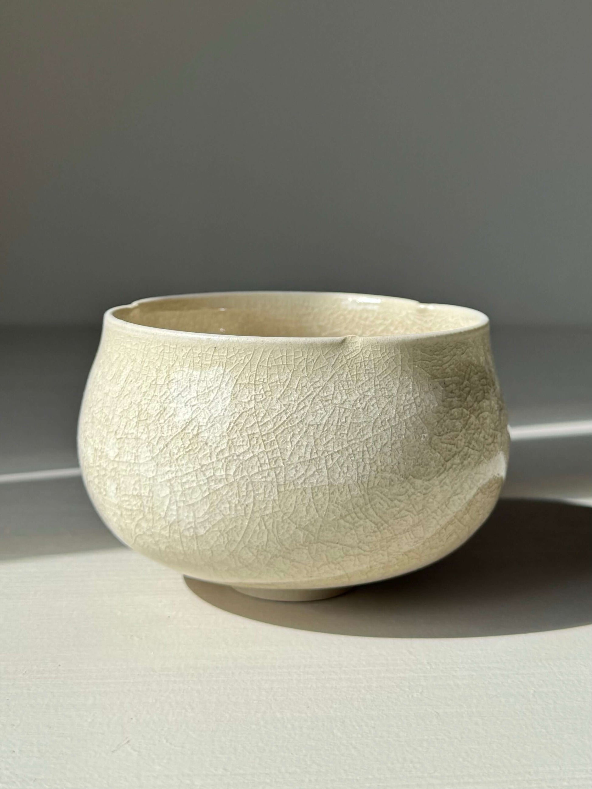 Alt Tag: Yunomi Cup - Kannyū Series #12 handmade ceramic with transparent crackle glaze on a softly flowing rim.