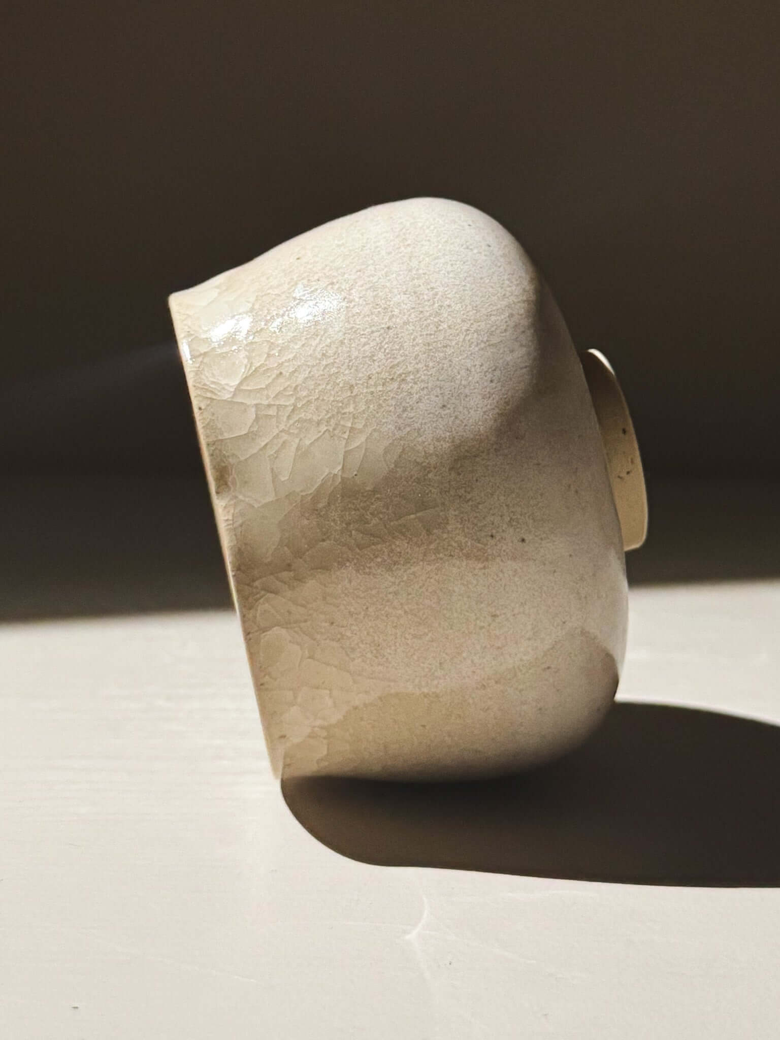 Yunomi Cup - Kannyū Series  #12 with a crackle glaze finish reflecting light.