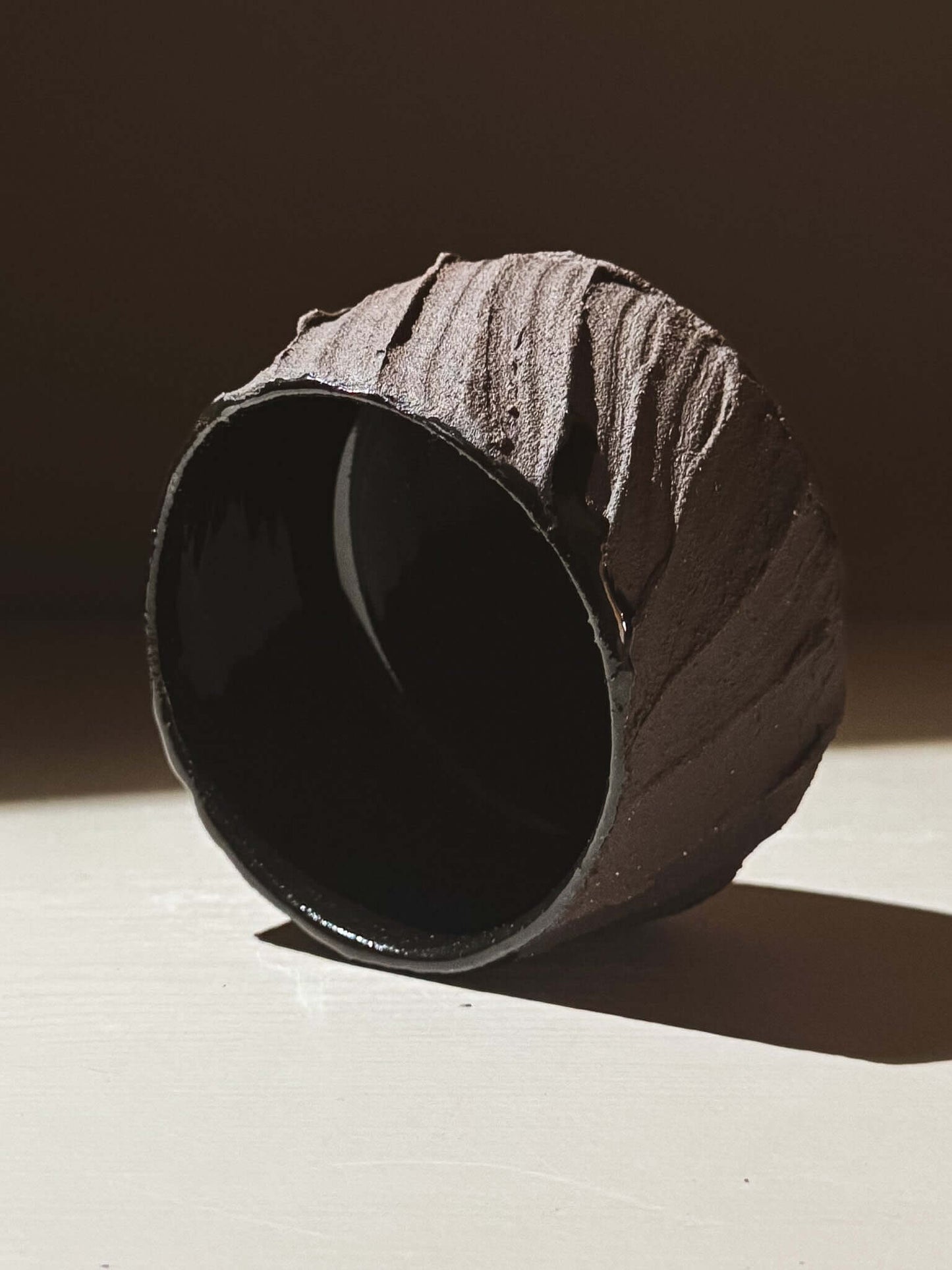 Yunomi Cup - Kuro #02 with textured dark brown clay exterior and glossy black interior.