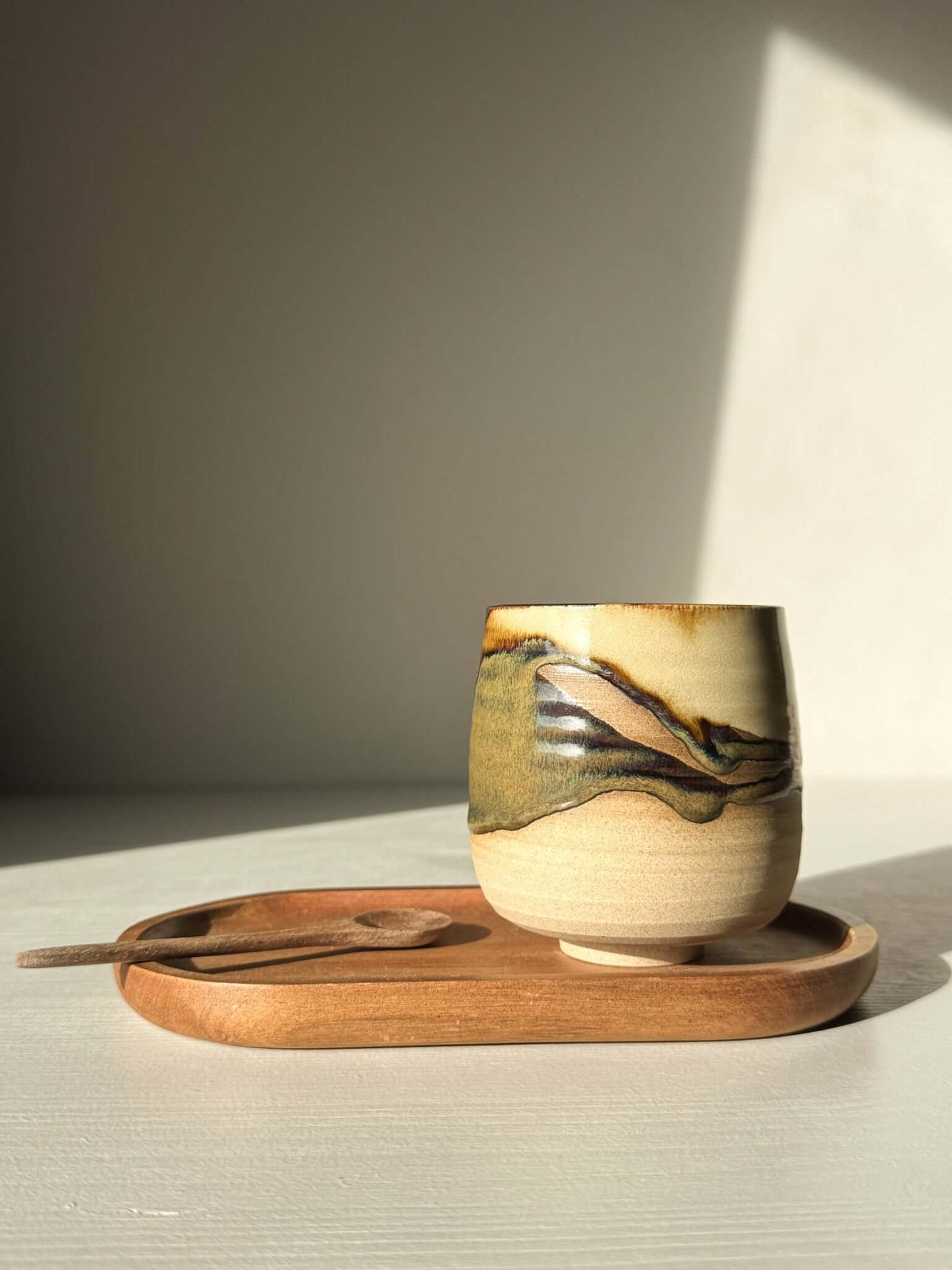 Yunomi Cups - Inyo with soft white glaze over toffee clay, showcasing natural texture on a wooden tray