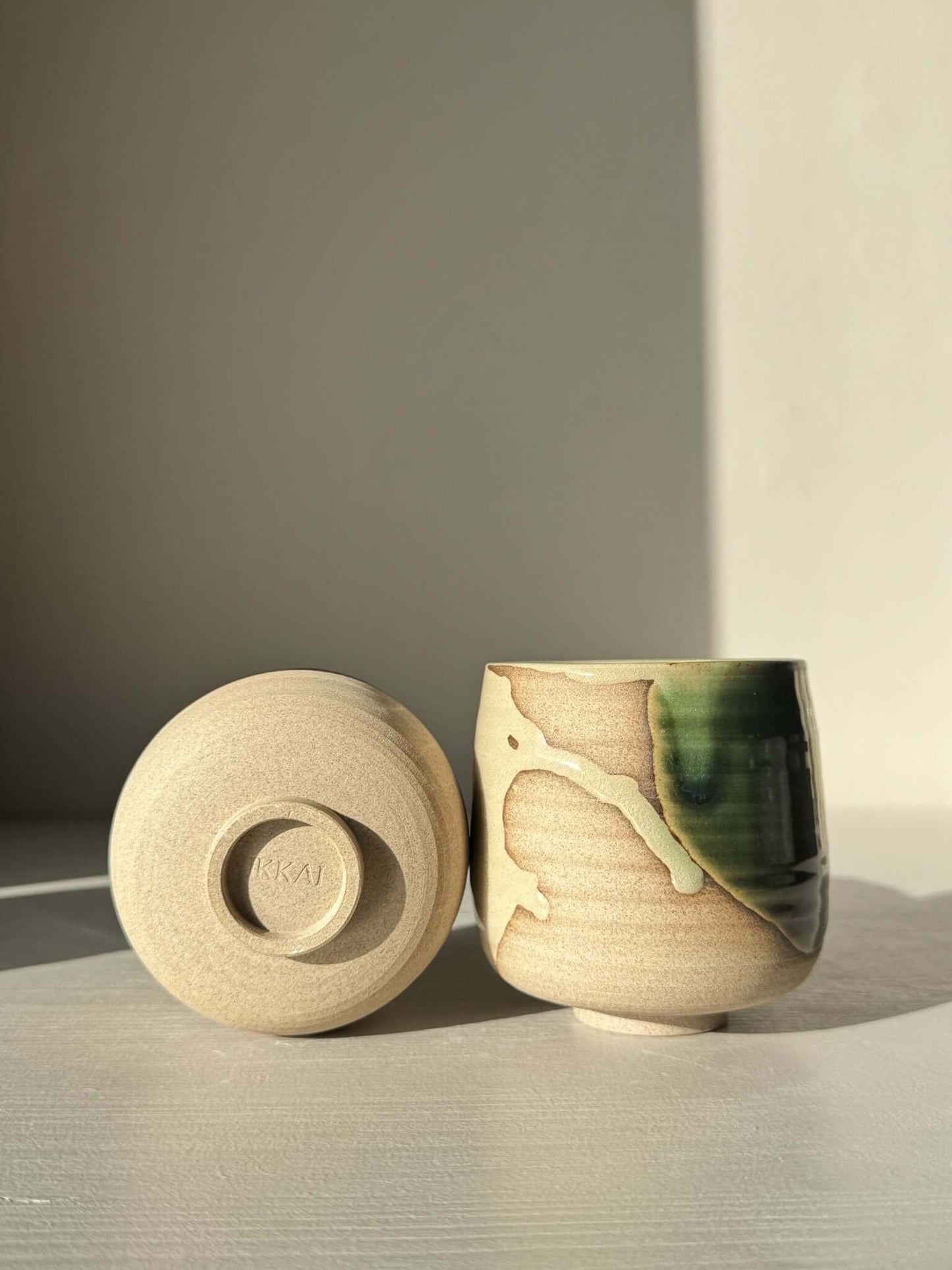Yunomi Cups - Mori with glossy forest-green and clear glaze on toffee clay, showcasing serene design with soft transitions and light shifts.