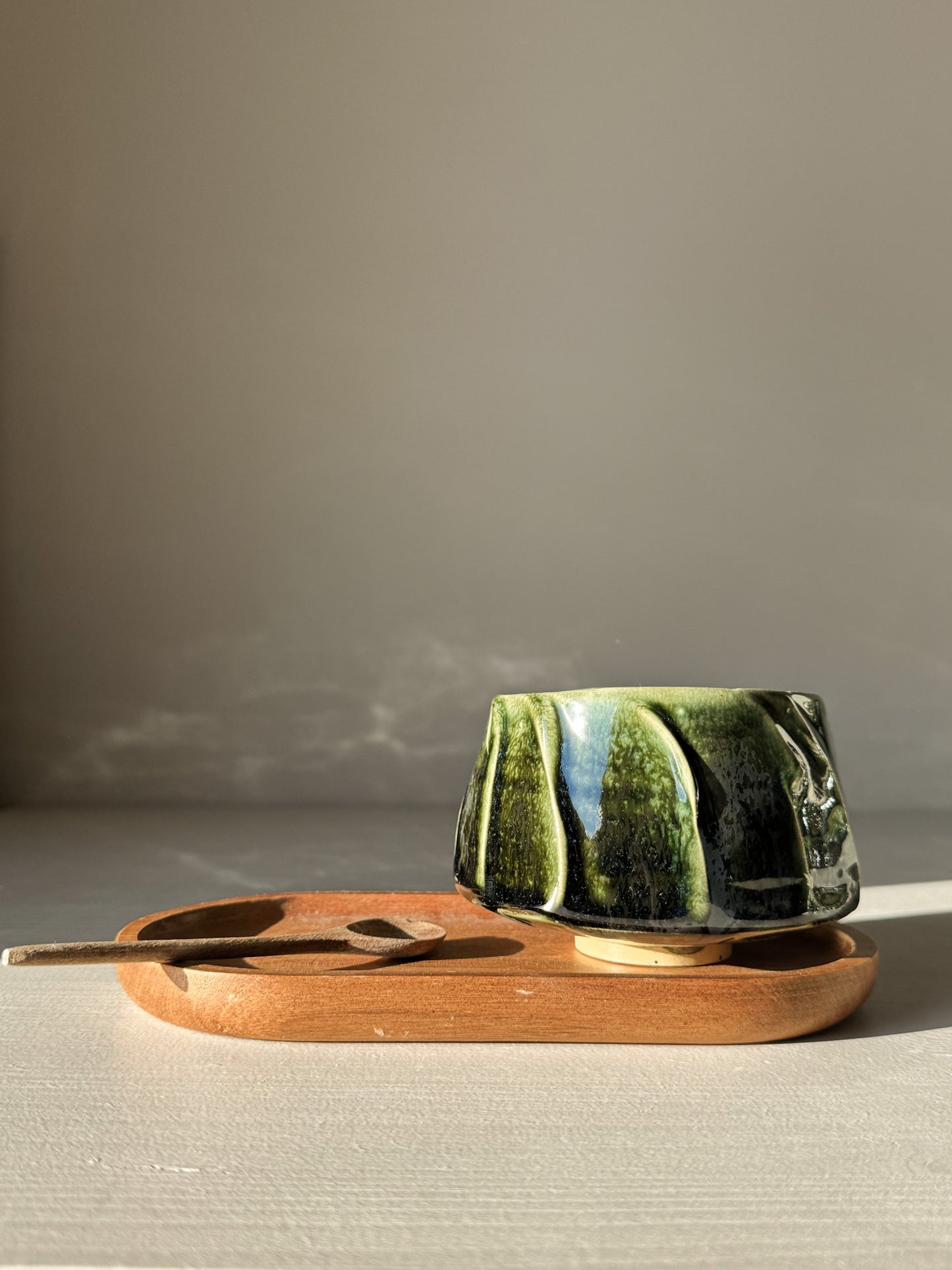 Yunomi Cup - Hinoki #02 on wooden tray, handmade with deep green glaze and flowing slip lines, perfect for everyday tea moments.