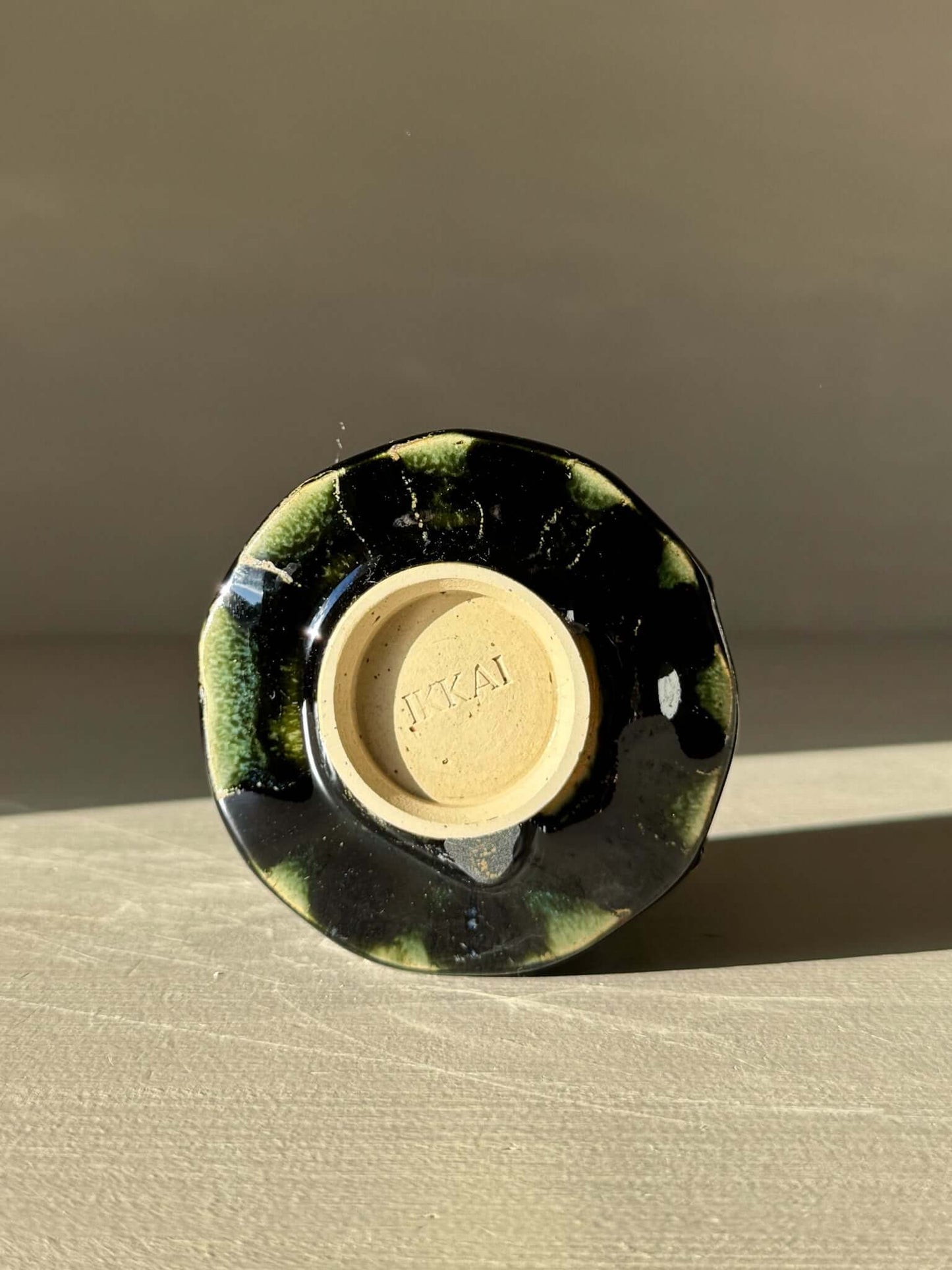 Bottom view of Yunomi Cup - Hinoki #13 showcasing deep green glaze and unique texture from the Hinoki Series.