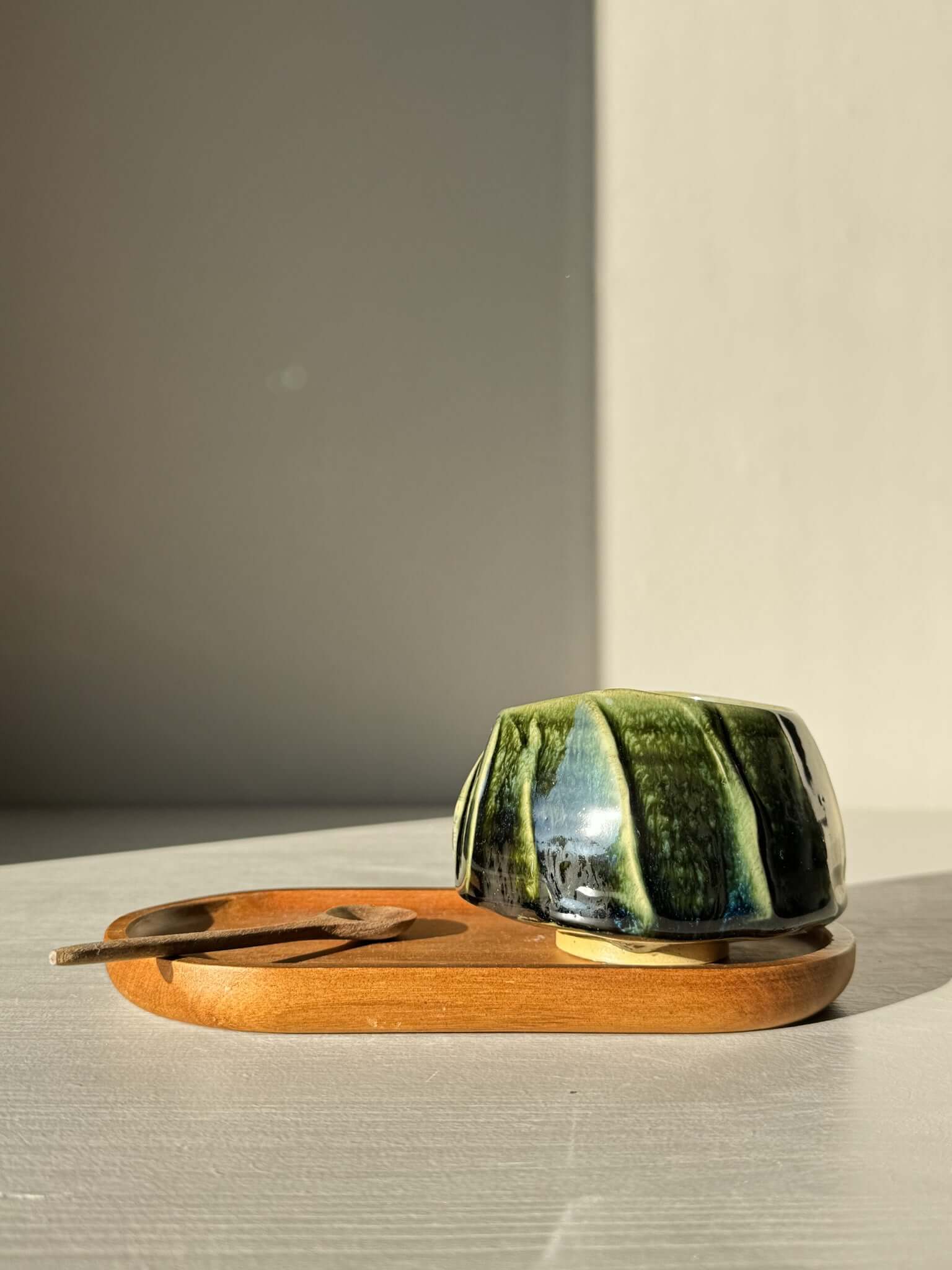 Yunomi Cup - Hinoki #30 handcrafted with deep green glaze on a wooden tray, highlighting slip decoration and unique texture.