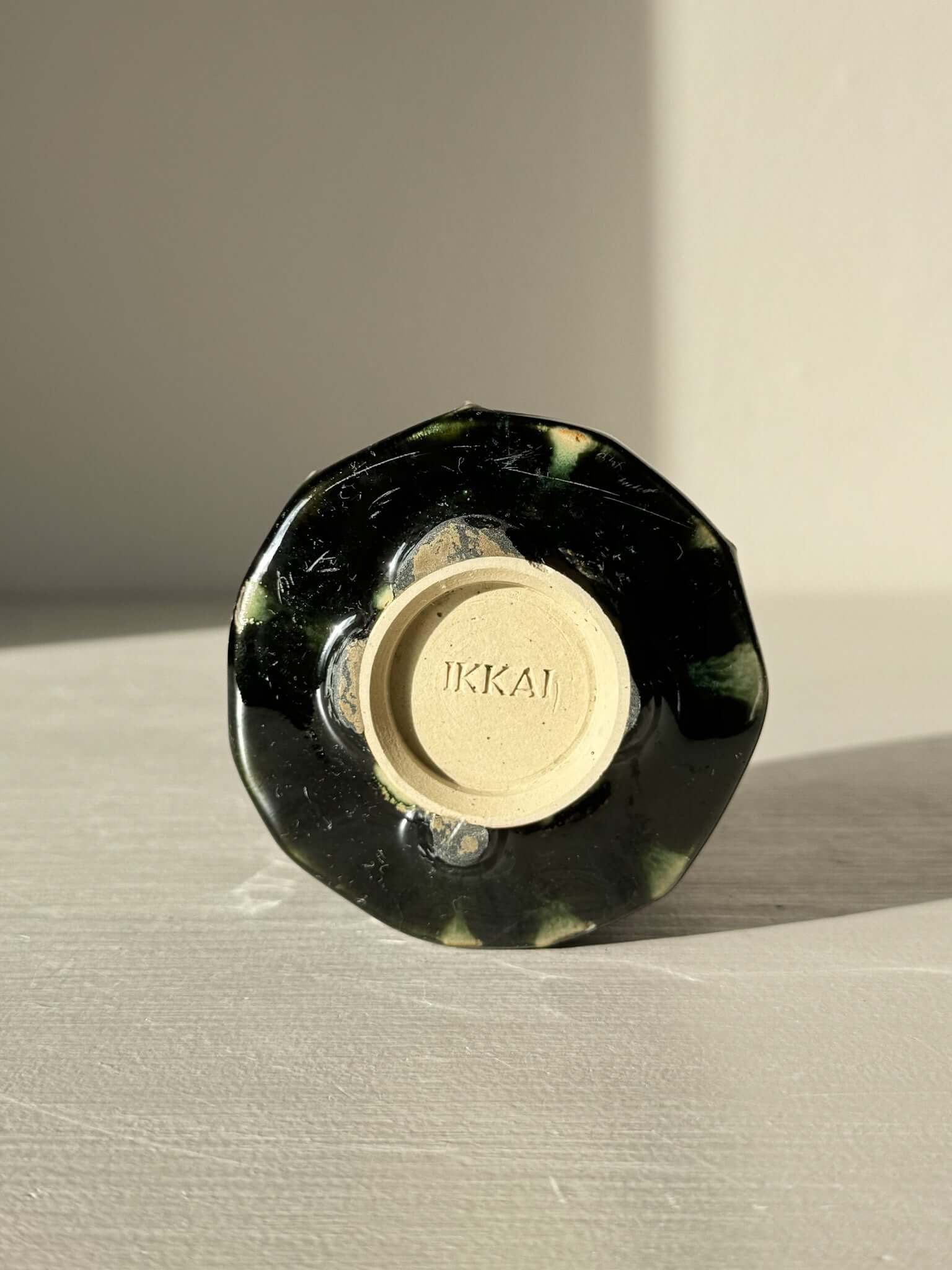 Bottom view of Yunomi Cup - Hinoki Series #19 with deep green glaze and unique slip texture, showcasing its handcrafted design.