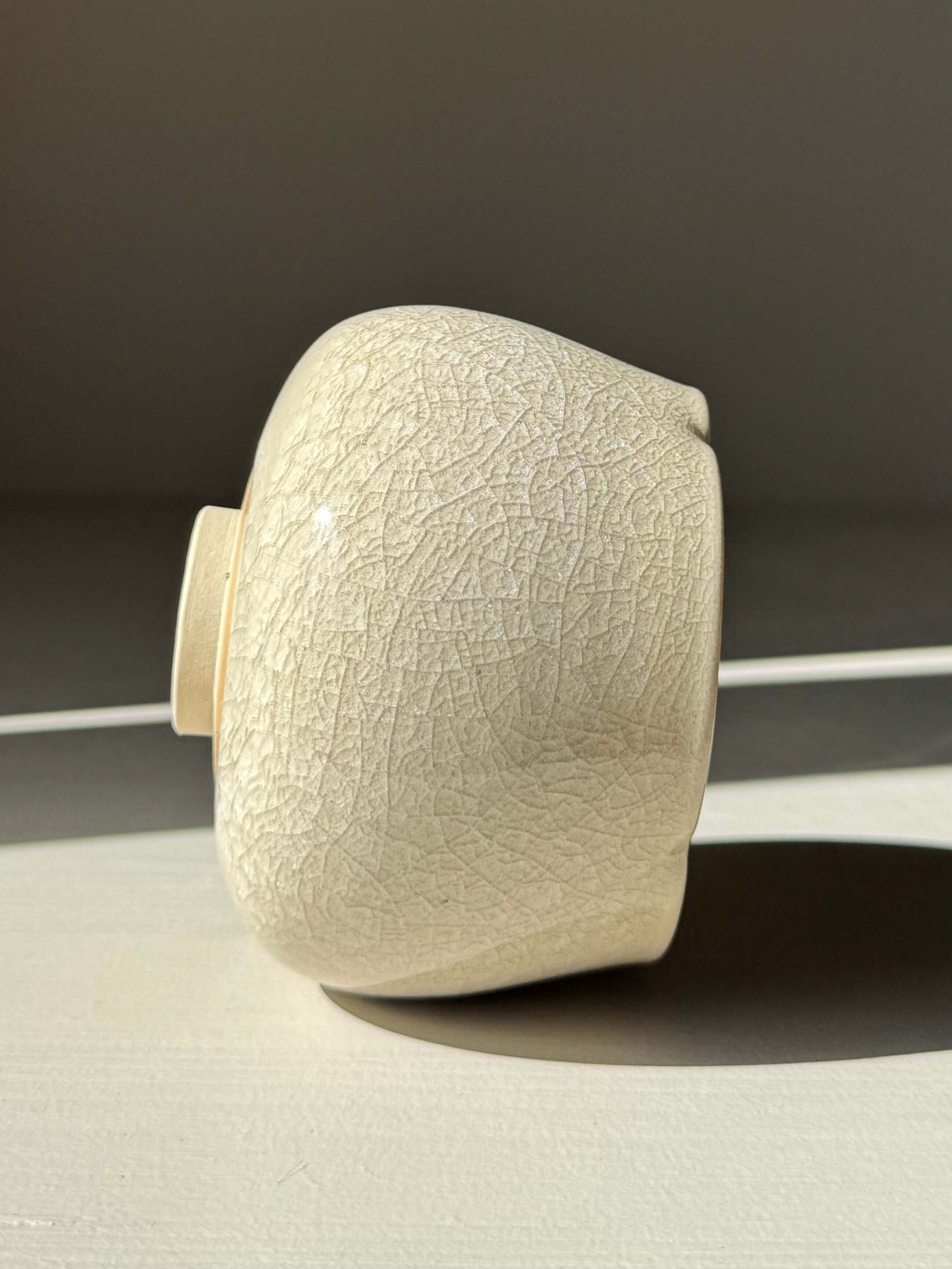 Yunomi Cup - Kannyū Series #04, handmade ceramic with transparent crackle glaze, showcasing fine lines and elegant form.