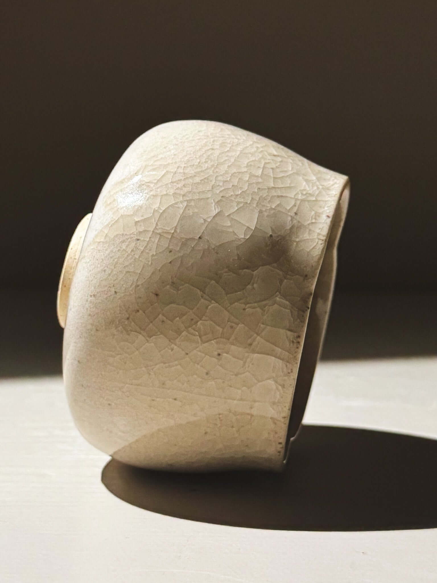 Yunomi Cup - Kannyū Series  #10 displayed in elegant side view, showcasing its crackle glaze and softly flowing rim.