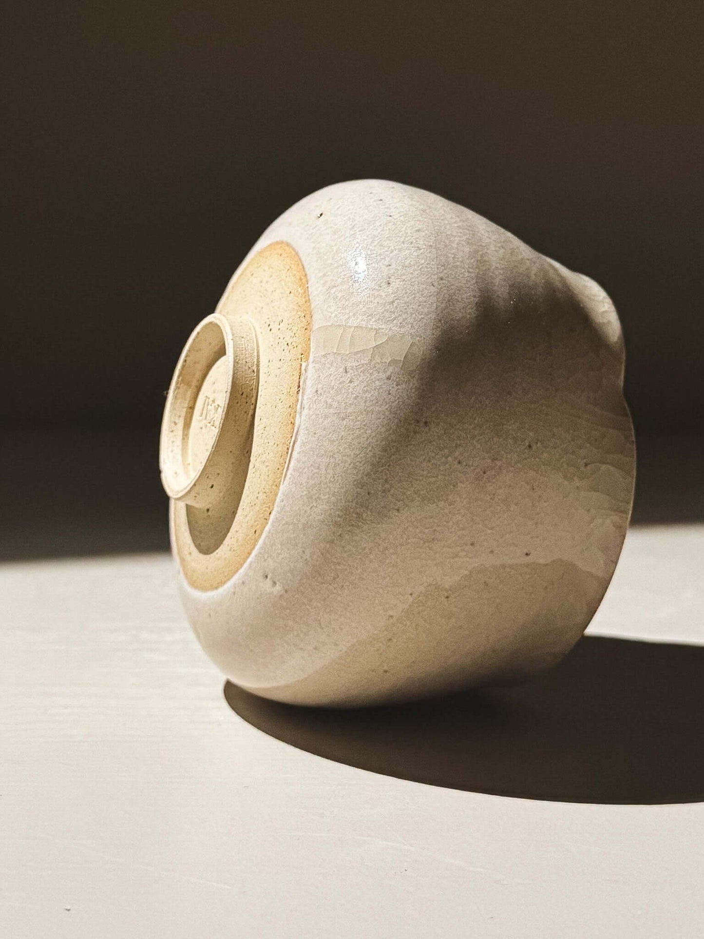 Yunomi Cup - Kannyū Series  #12 with delicate crackle glaze and softly flowing rim on display.
