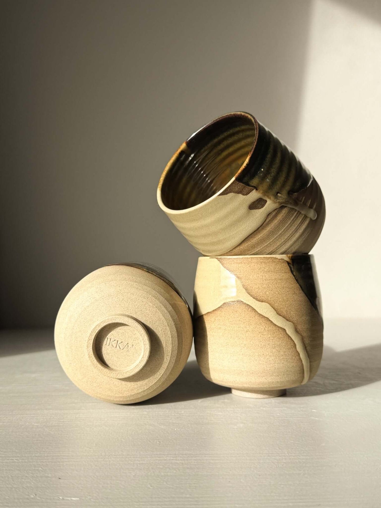 Yunomi Cups - Inyo with toffee clay and white glaze, showcasing raw texture and glossy finish.