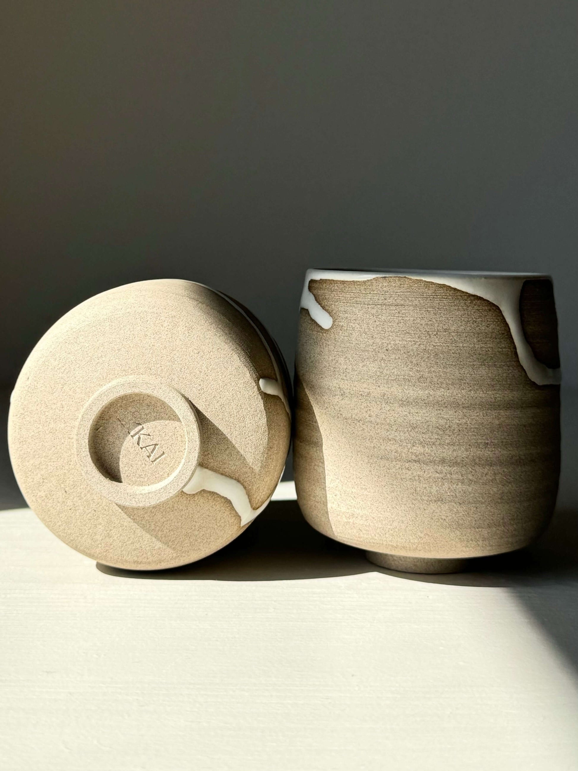 Yunomi Cups from Yuki Series in soft white glaze over toffee clay, showcasing unique drips and artisanal craftsmanship.